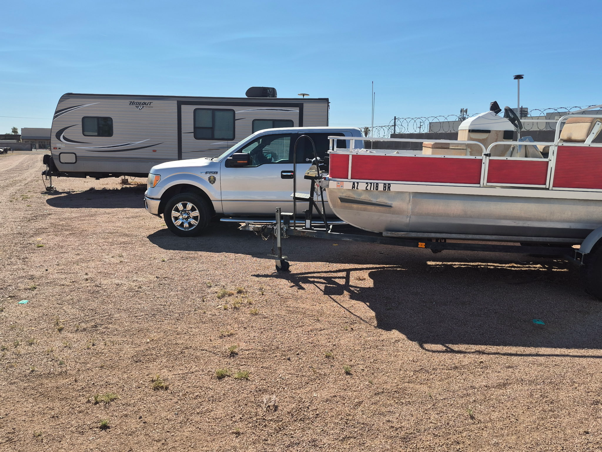 Pontoon boat with RV storage spaces behind it