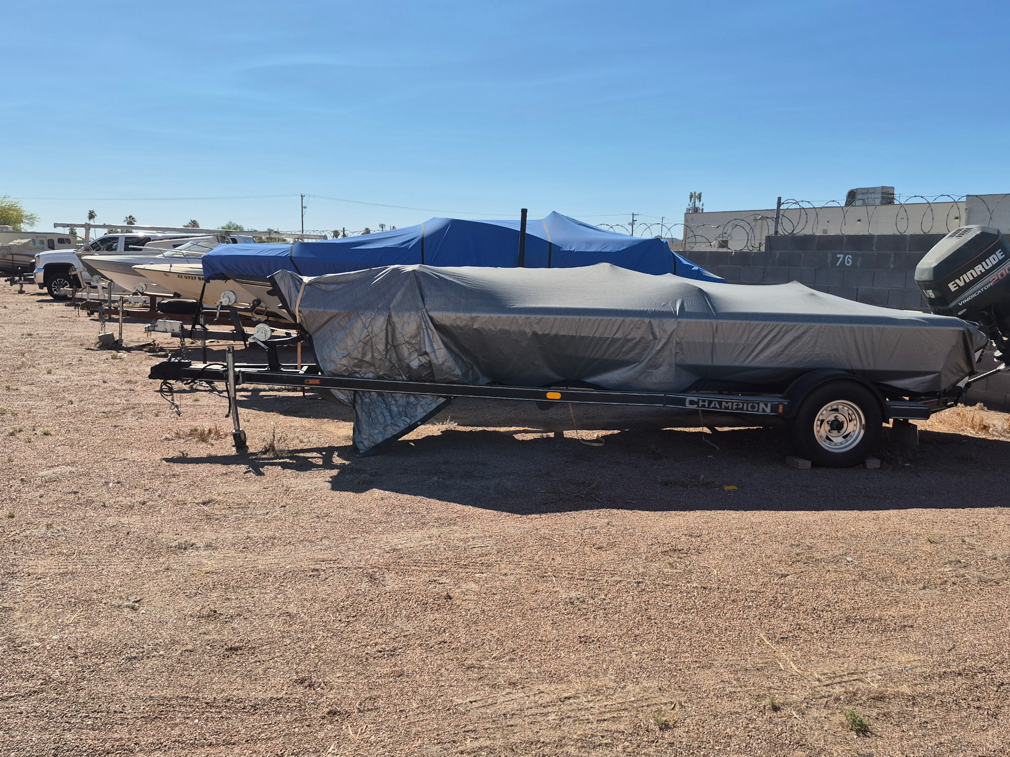 Covered boats parked in the storage yard