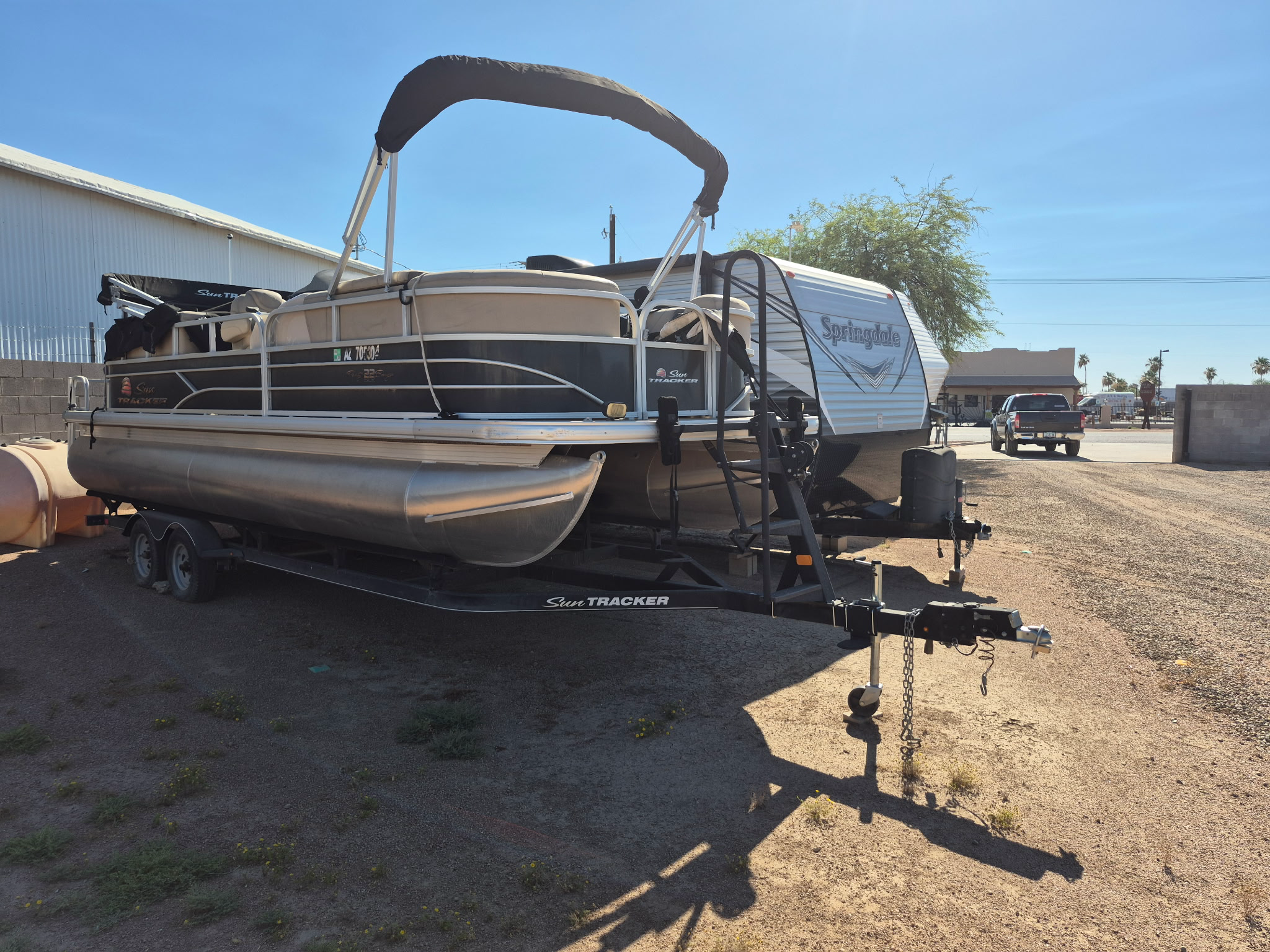 Pontoon boat and travel trailer stored on the property