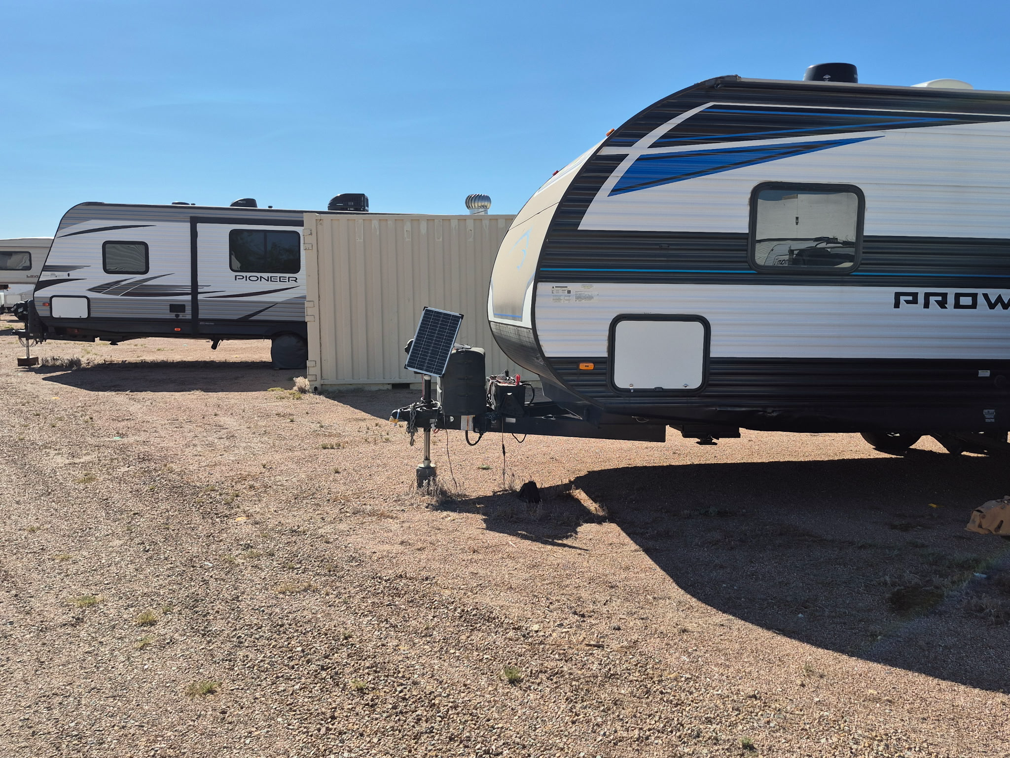 Travel trailers parked in the property storage rows