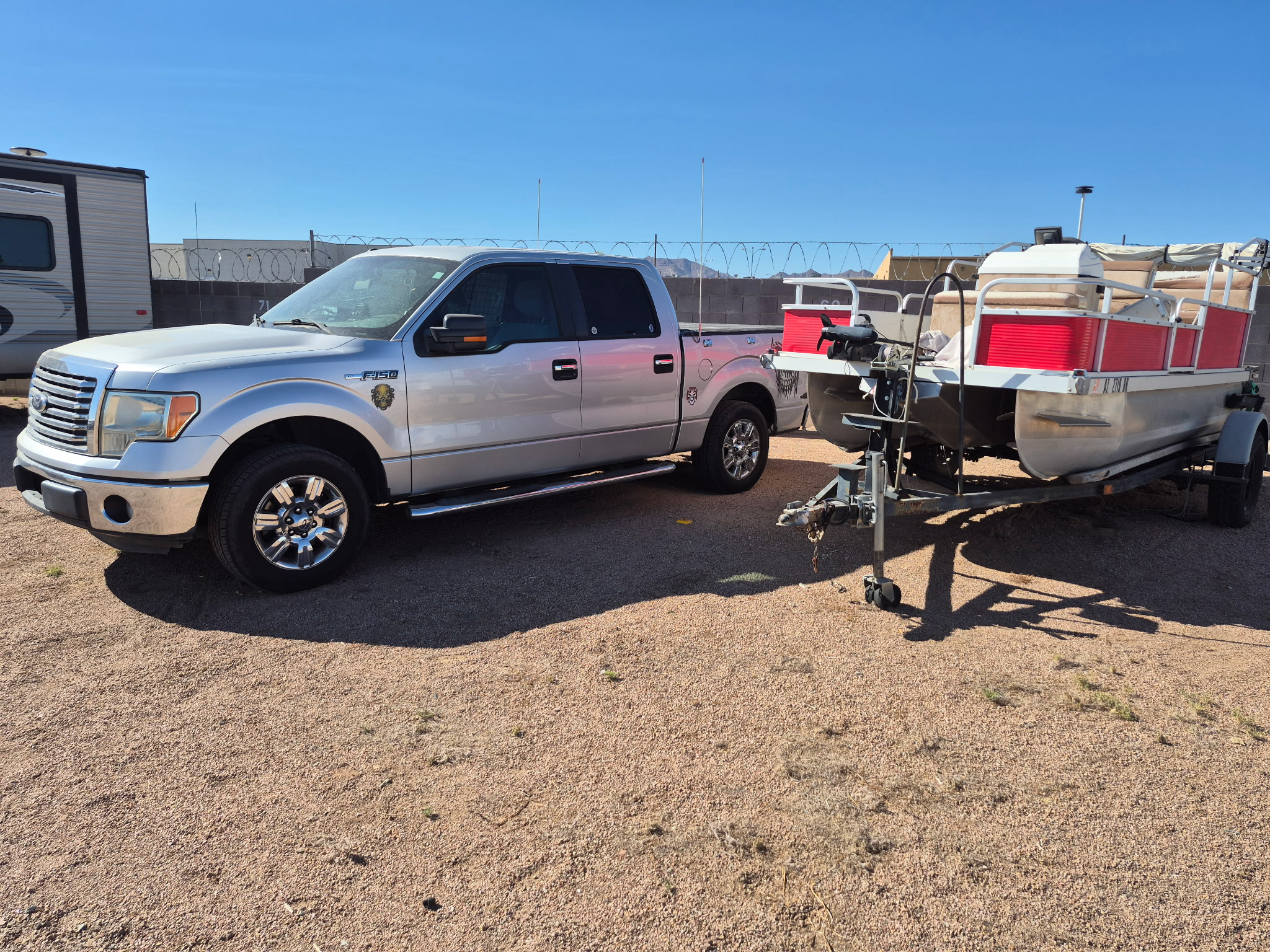 Pickup truck and pontoon boat in the storage yard